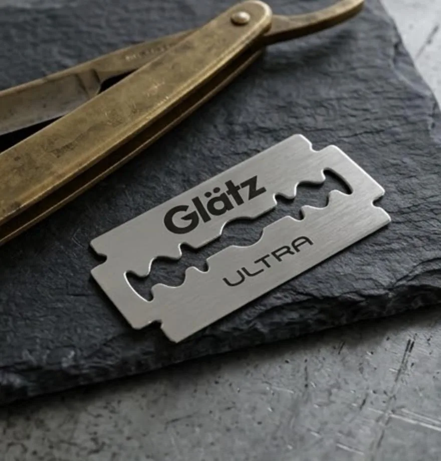 Glätz Ultra blade on slate beside a vintage straight razor